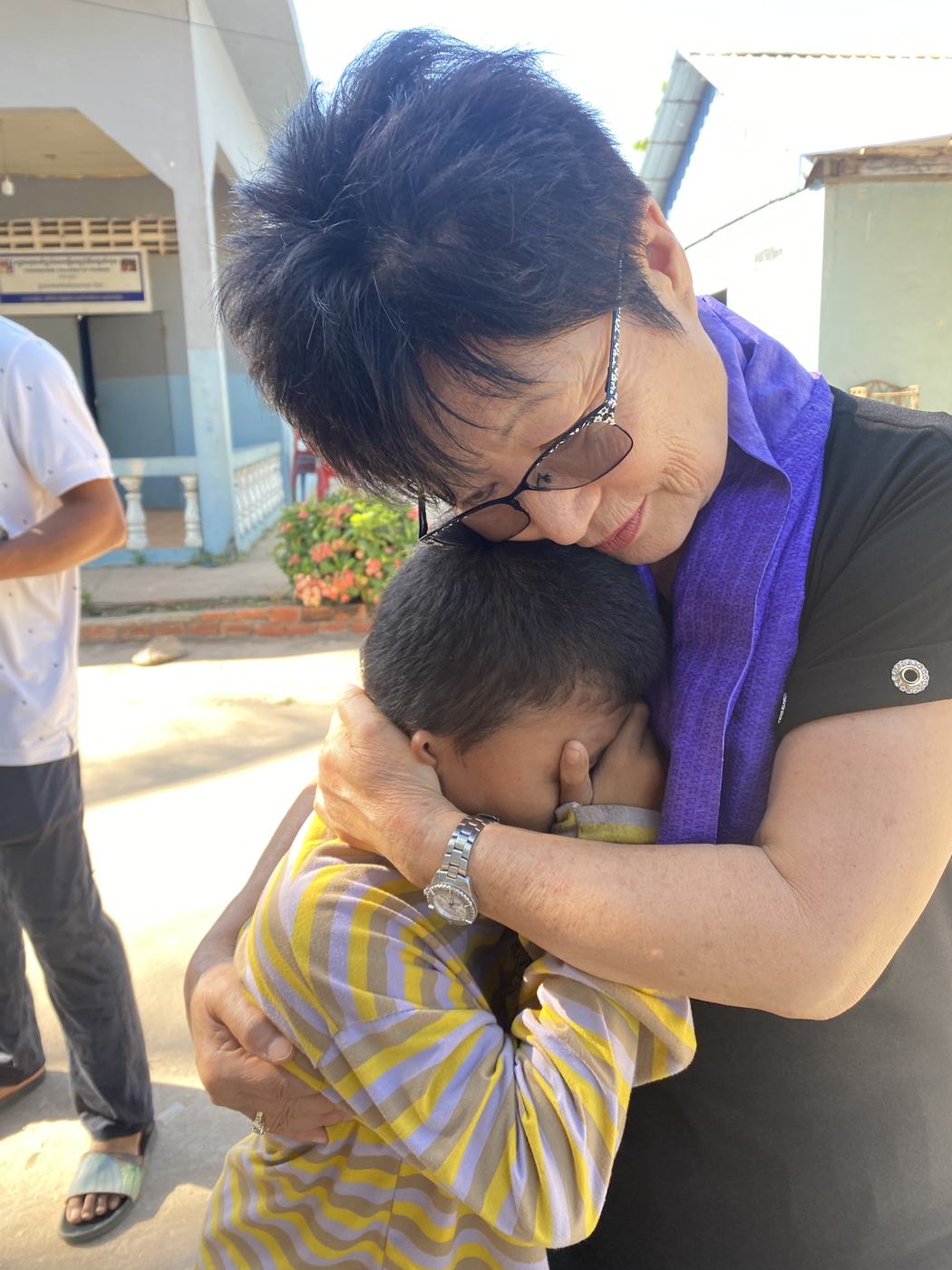 Prophet Soonhe Young embracing a young boy in Cambodia